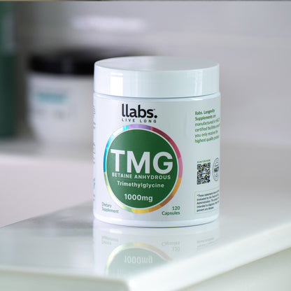 A container of llabs. TMG (Betaine) Capsules dietary supplement with 120 capsules designed to enhance your daily routine, positioned on a white surface.